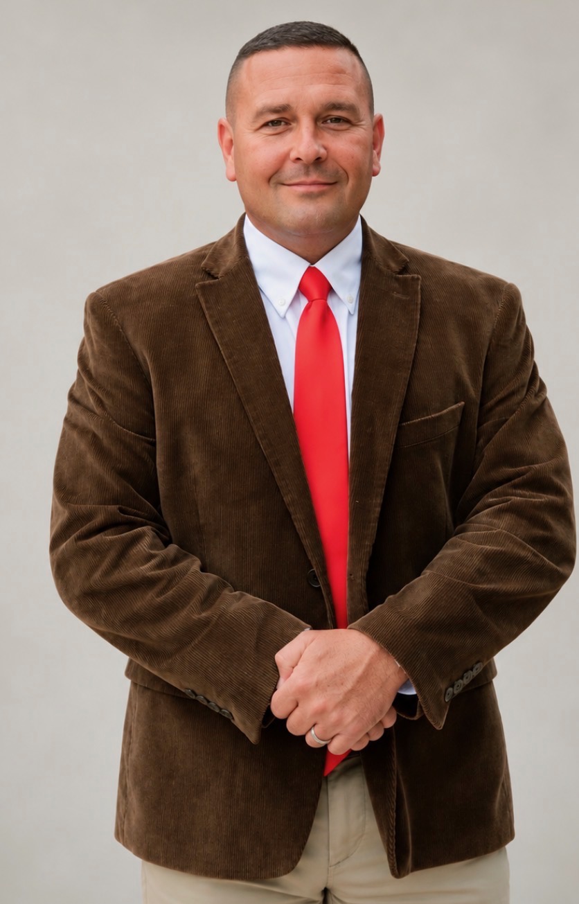David Clayman wearing a brown jacket and red tie